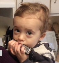 Aidan playing the harmonica.